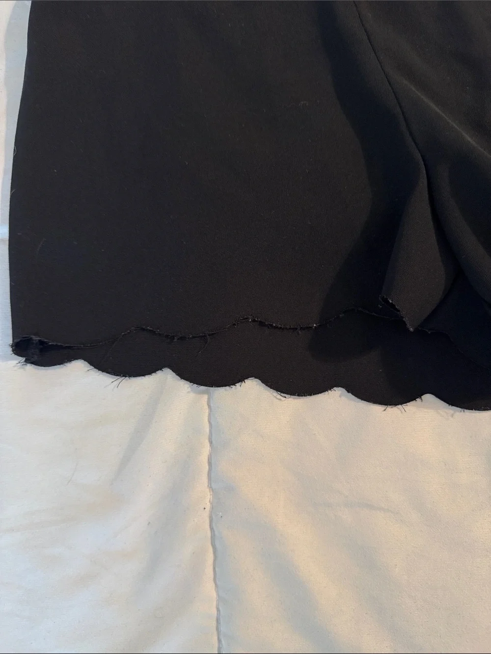 H&M Black High-Waist Scalloped Hem Shorts with side zipper.